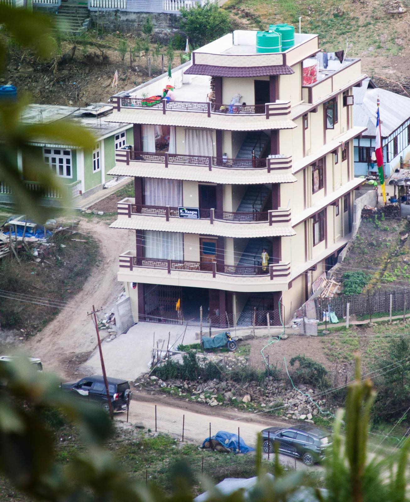 Nangsa Homestay multi-storey building exterior with prayer flags Dirang Arunachal Pradesh