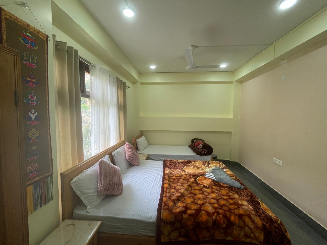 Nangsa Homestay Green Twin Room with traditional Tibetan thangka decor Dirang Arunachal Pradesh